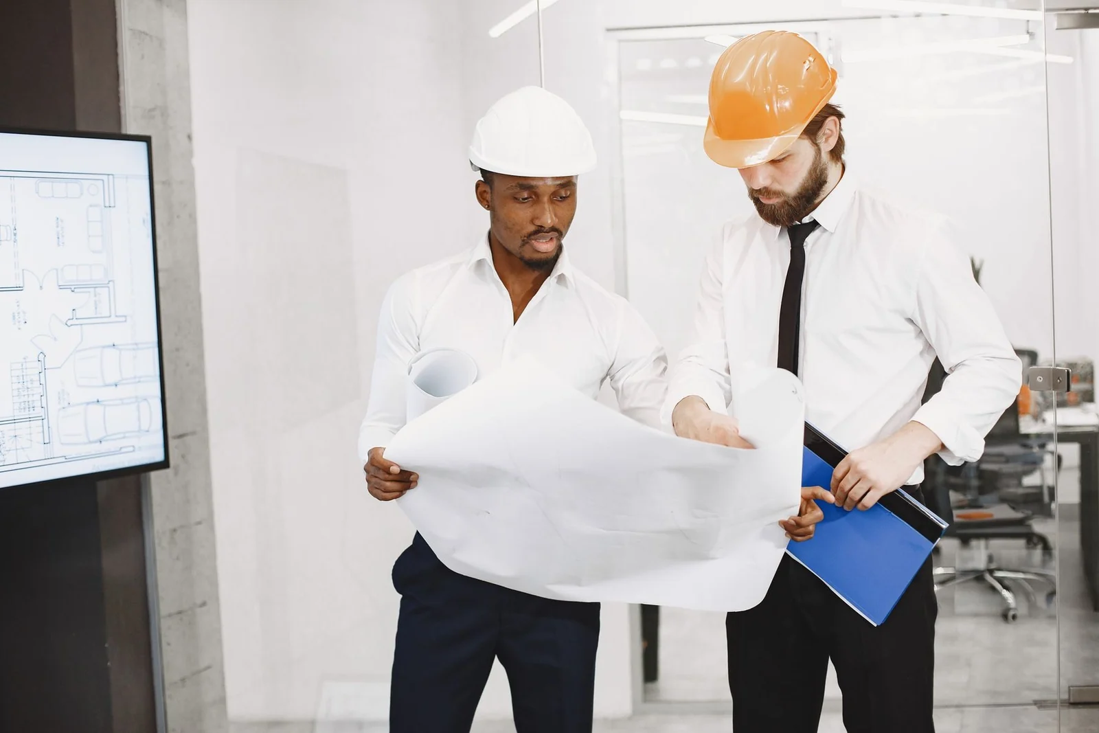 Two architects reviewing project plans together.
