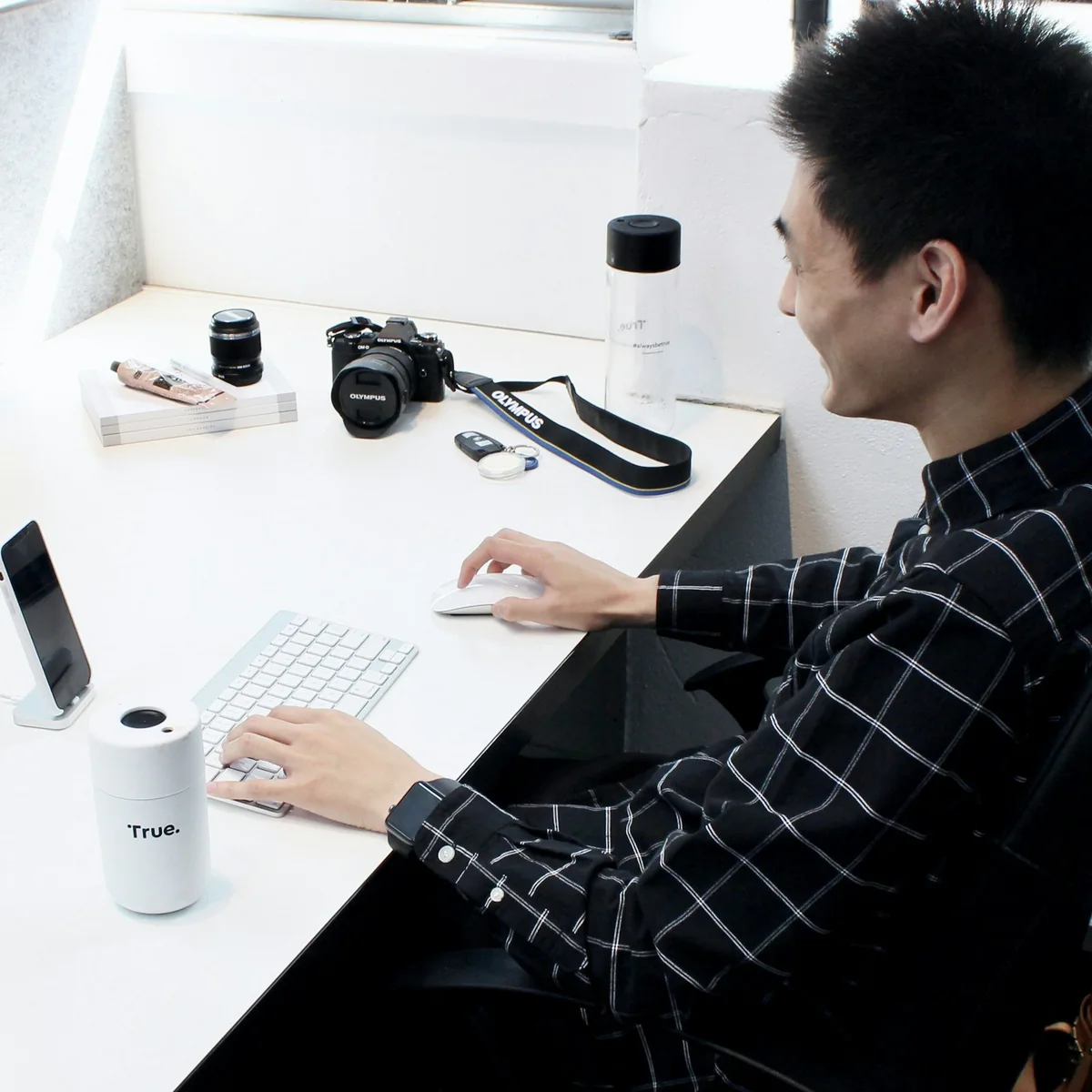 Creative professional working on digital design at a studio workstation.